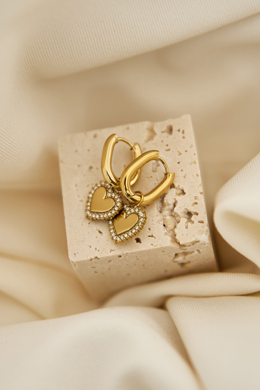 Squoval earrings with heart charms with set edges