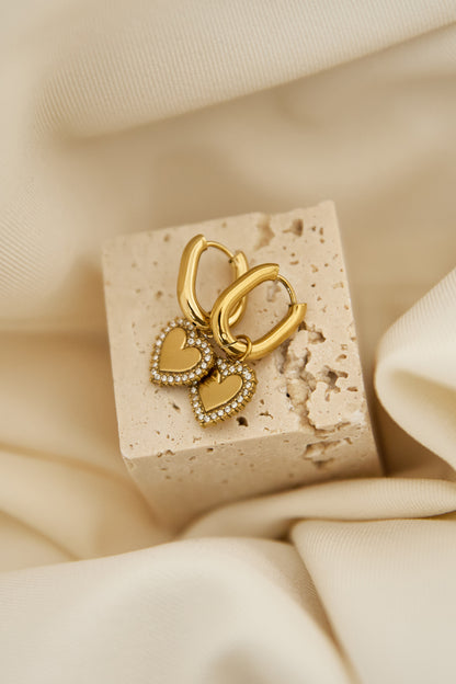 Squoval earrings with heart charms with set edges
